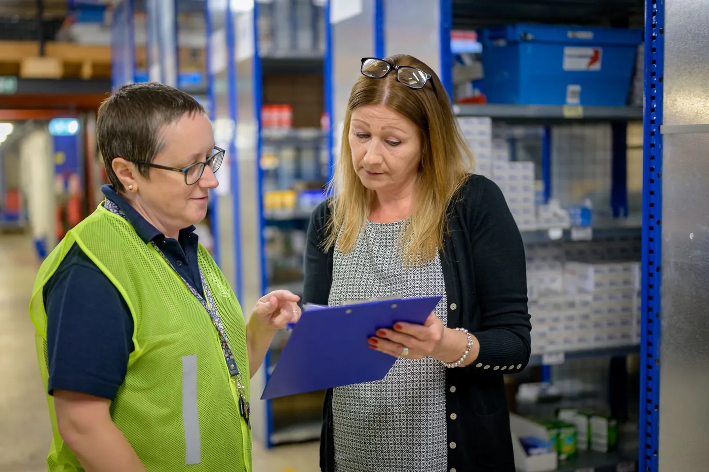 Two people reviewing inventory in a warehouse